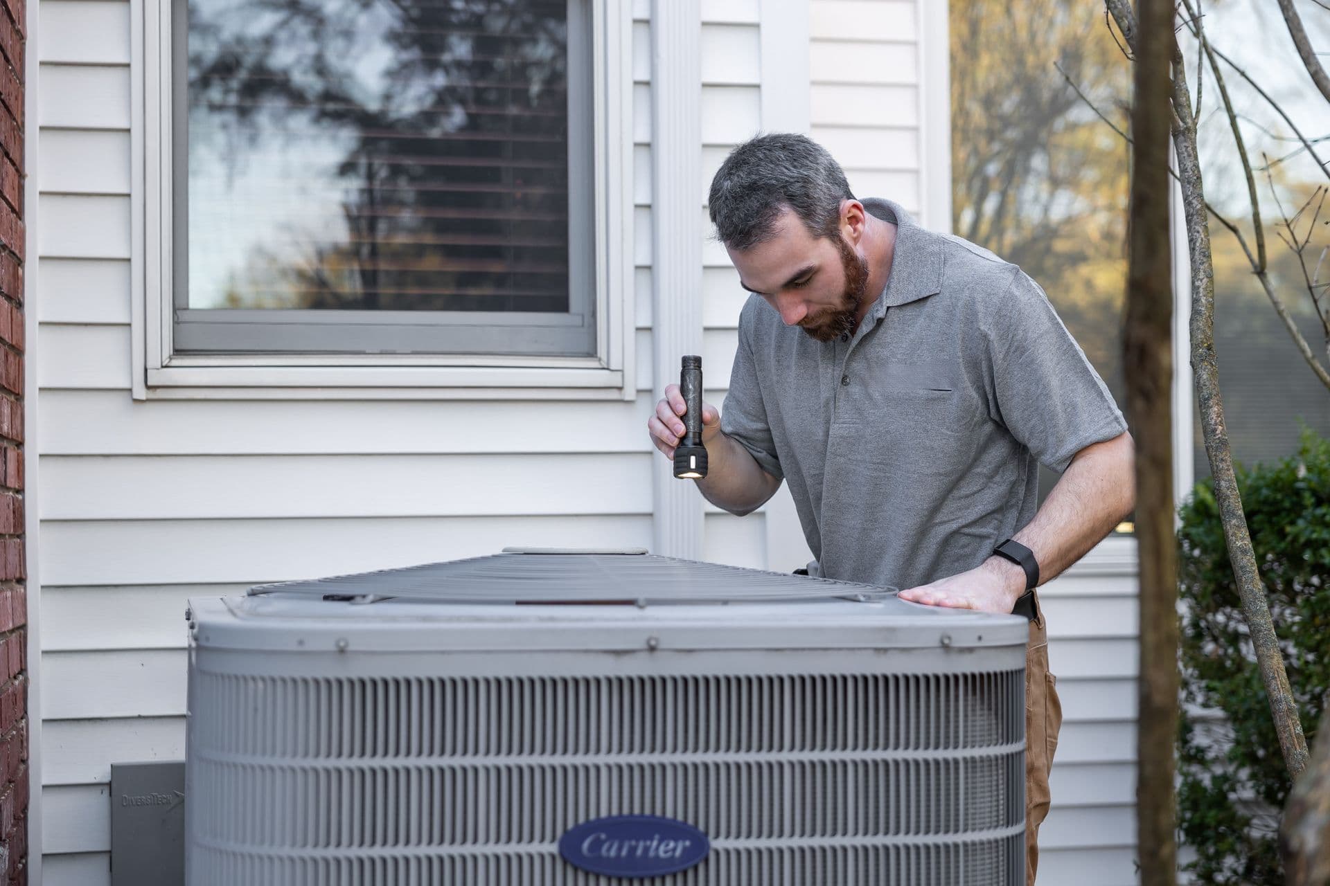 Licensed HVAC Service Florida technician servicing a home HVAC system in Florida
